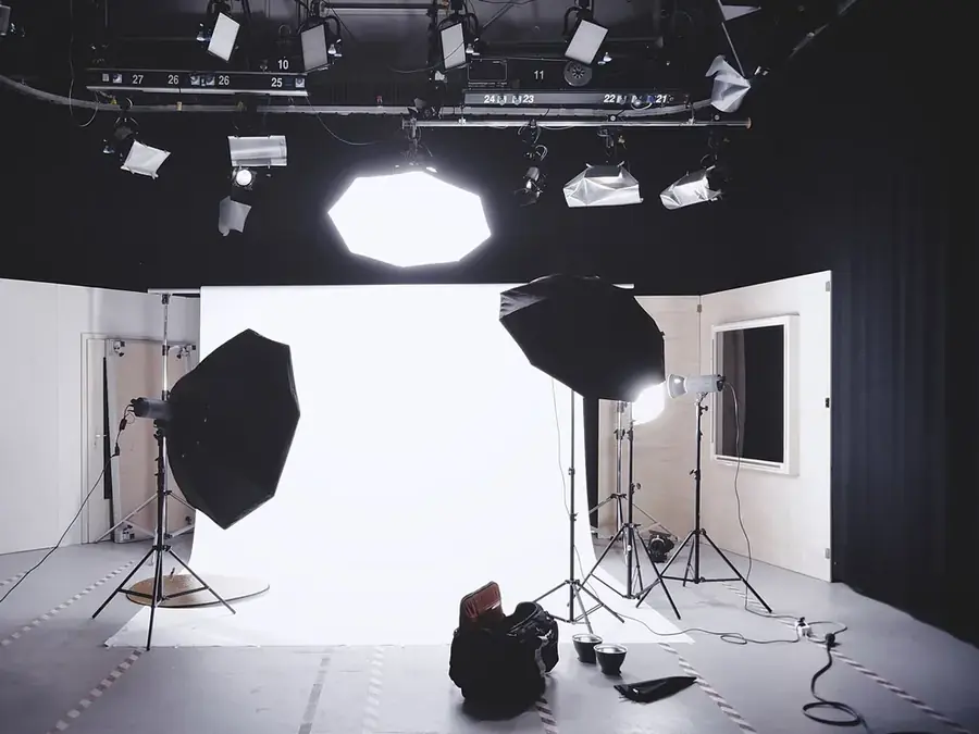 Softbox lights on stands in front of a white studio backdrop